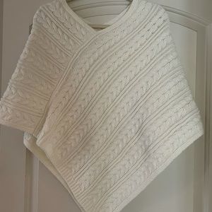 Cream colored cable knit sweater poncho